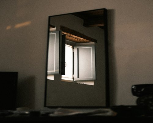 Italian window with soft daylight casting shadows in a room